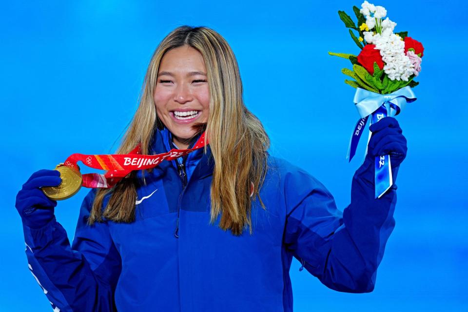 Chloe Kim poses with her gold medal from the 2022 Beijing Olympics.