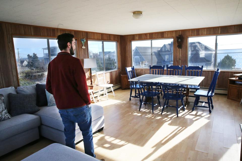 John Guy, an agent of Jean Knapp Rentals, poses inside a short-term rental property on Nubble Road in York. The house is one of the many that could be affected by new regulations on short-term rentals in the town.