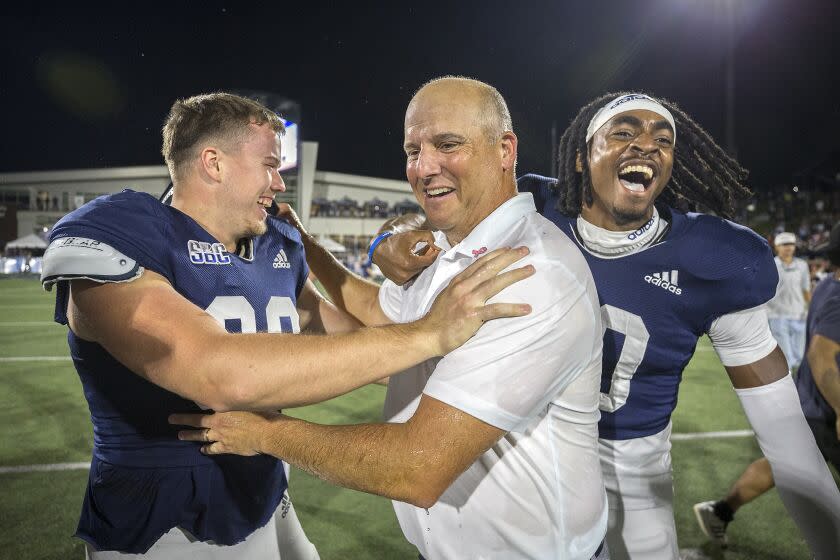 Georgia Southern head coach Clay Helton, center, celebrates with Georgia Southern.