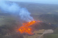 This image provided by the Icelandic Coast Guard shows a volcano on the Reykjanes Peninsula in southwestern Iceland on Saturday March 20, 2021. A long dormant volcano on the Reykjanes Peninsula flared to life Friday night, spilling lava down two sides in that area's first volcanic eruption in nearly 800 years. Initial aerial footage, posted on the Facebook page of the Icelandic Meteorological Office, showed a relatively small eruption so far, with two streams of lava running in opposite directions. (Icelandic Coast Guard via AP)