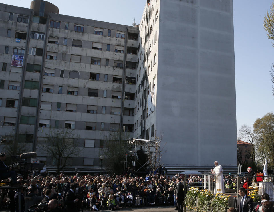 Pope Francis, bottom right, delivers his message at Milan's Forlanini neighborhood known as Case Bianche (white houses), as part of his one-day pastoral visit to Monza and Milan, Italy’s second-largest city, Saturday, March 25, 2017. The pope's first stop Saturday is a housing project on the outskirts of Italy's fashion and finance capital, a stop that underlines the pope's view that the peripheries offer a better view of reality than well-tended and prosperous city centers. (AP Photo/Antonio Calanni)