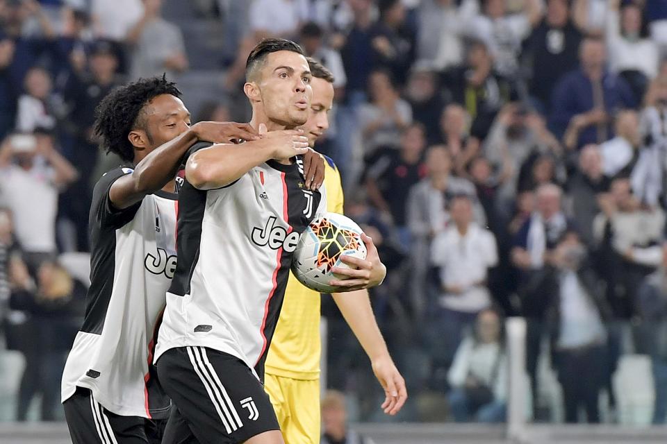 TURIN, ITALY - SEPTEMBER 21: Cristiano Ronaldo of Juventus celebrates after his goal of 2-1 with teammate Juan Cuadrado during the Serie A match between Juventus and Hellas Verona at Allianz Stadium on September 21, 2019 in Turin, Italy.  (Photo by Daniele Badolato - Juventus FC/Juventus FC via Getty Images)