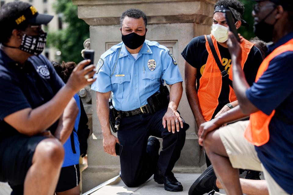 Lansing Police Chief Daryl Green kneels with demonstrators at the State Capitol in Lansing on June 10, 2020, in Lansing. The event was organized by the Michigan NAACP Youth and College Division.