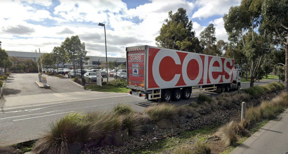 Pictured is a Coles truck driving outside the distribution centre in Laverton, where a worker tested positive for the coronavirus. 