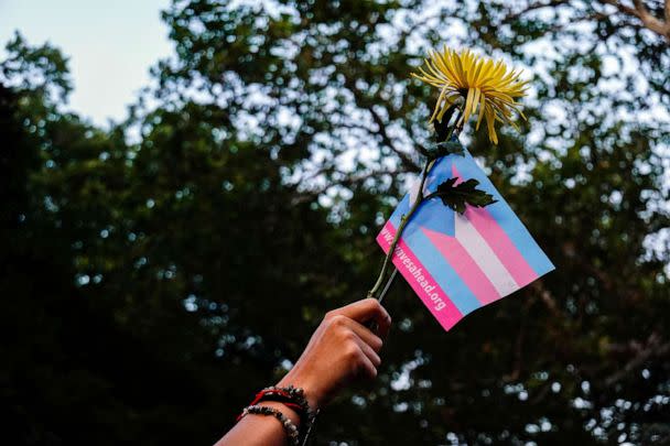 PHOTO: FILE - A person holds a transgender pride flag and a flower during a Black Trans Liberation protest in New York,May 31, 2023. (Amr Alfiky/Reuters, FILE)