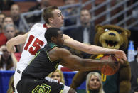 Wisconsin forward Sam Dekker (15) and Baylor guard Kenny Chery reach the ball during the first half of an NCAA men's college basketball tournament regional semifinal, Thursday, March 27, 2014, in Anaheim, Calif. (AP Photo/Mark J. Terrill)