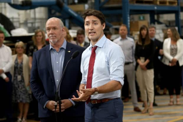 Premier John Horgan, left, and Prime Minister Justin Trudeau during a news conference in 2019. Horgan told British Columbians this week that further restrictions could be coming to curb the spread of COVID-19. ( THE CANADIAN PRESS/Chad Hipolito - image credit)