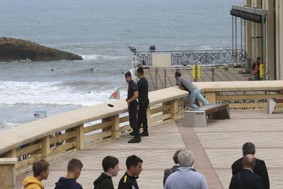 Riot police officers patrol by the municipal Casino, a venue of the upcoming G7 summit, Tuesday, Aug.20, 2019 in Biarritz, southwestern France. French police are setting up checkpoints and combing Atlantic beaches to secure the southwestern coast for world leaders coming for the G-7 summit. (AP Photo/Bob Edme)