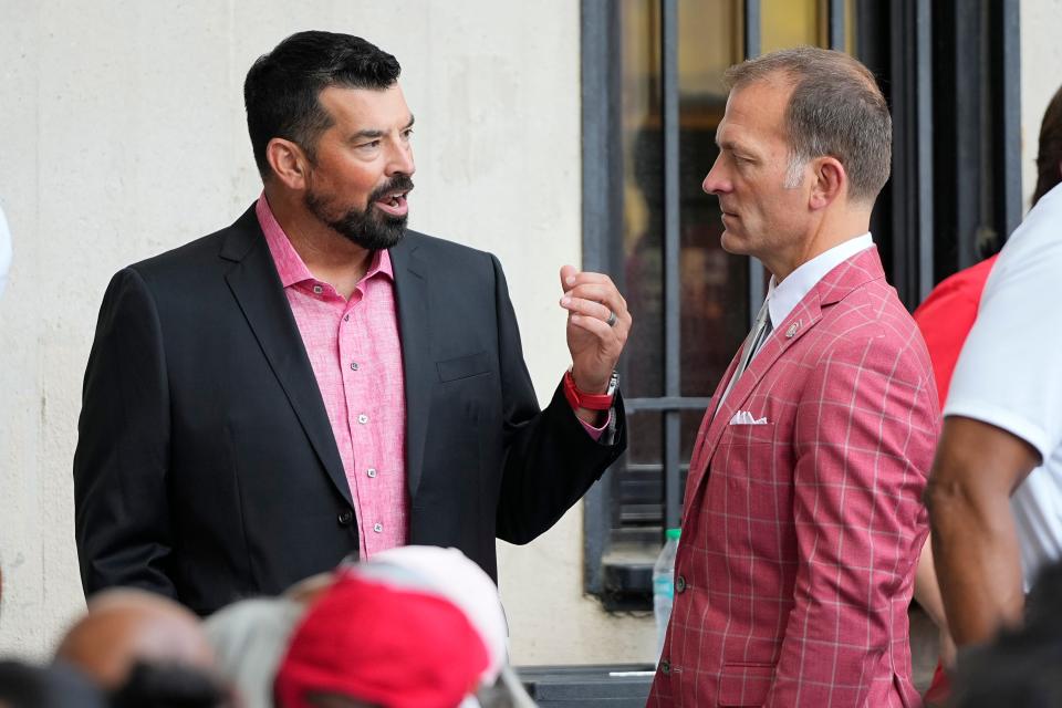 Aug 30, 2024; Columbus, OH, USA; Ohio State Buckeyes head coach Ryan Day and athletic director Ross Bjork attend the unveiling of a statue for former Buckeyes running back Archie Griffin outside Ohio Stadium.