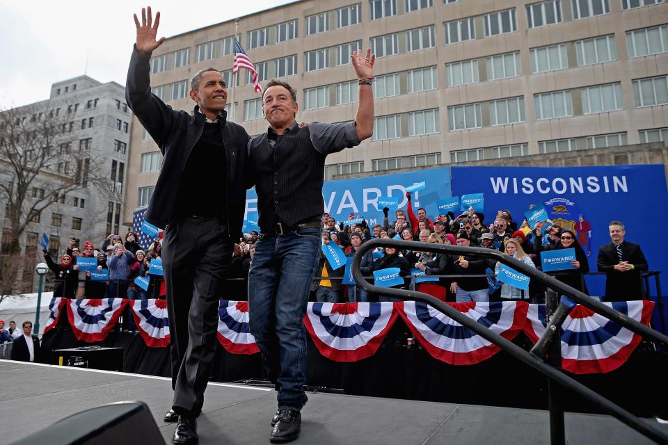 U.S. President Barack Obama and rocker Bruce Springsteen wave to a crowd of 18,000 people during a rally on the last day of campaigning in the general election November 5, 2012 in Madison, Wisconsin. Obama and his opponent, Republican presidential nominee and former Massachusetts Gov. Mitt Romney are stumping from one 'swing state' to the next in a last-minute rush to persuade undecided voters. (Photo by Chip Somodevilla/Getty Images)