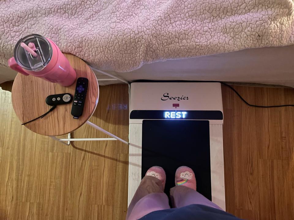 Hope Zuckerbrow, founder of the cozy cardio wellness movement, shows her workout set-up, including a walking pad, smoothie and remote control for watching television. (Hope Zuckerbrow via AP) ORG XMIT: NYCL402