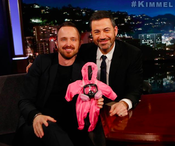 <p>Aw — a future baby meth maker! Dad-to-be Aaron Paul got a hilarious gift when he visited <i>Jimmy Kimmel Live</i> on Tuesday. The pink, mini-size hazmat suit was of course a nod to <i>The Path</i> star’s old show <i>Breaking Bad</i>, which saw his character manufacturing meth. Paul and his wife, Lauren, are expecting their first child any day now. (Photo: <a rel="nofollow noopener" href="https://www.instagram.com/p/BeUZEFoBWIt/?hl=en&taken-by=glassofwhiskey" target="_blank" data-ylk="slk:Aaron Paul via Instagram;elm:context_link;itc:0;sec:content-canvas" class="link ">Aaron Paul via Instagram</a>) </p>