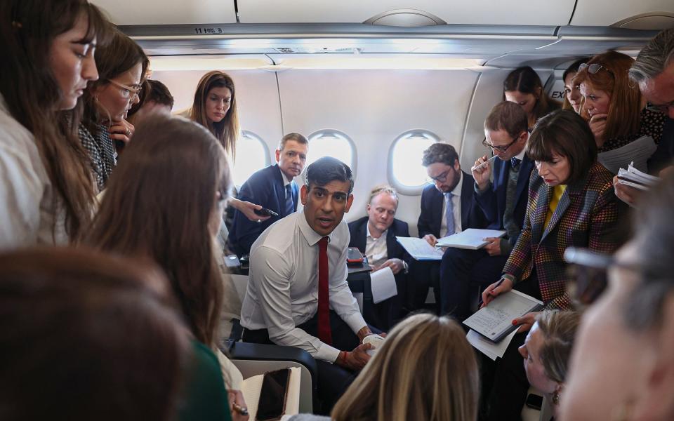 Rishi Sunak, the Prime Minister, is pictured speaking to reporters today as he travelled to Poland