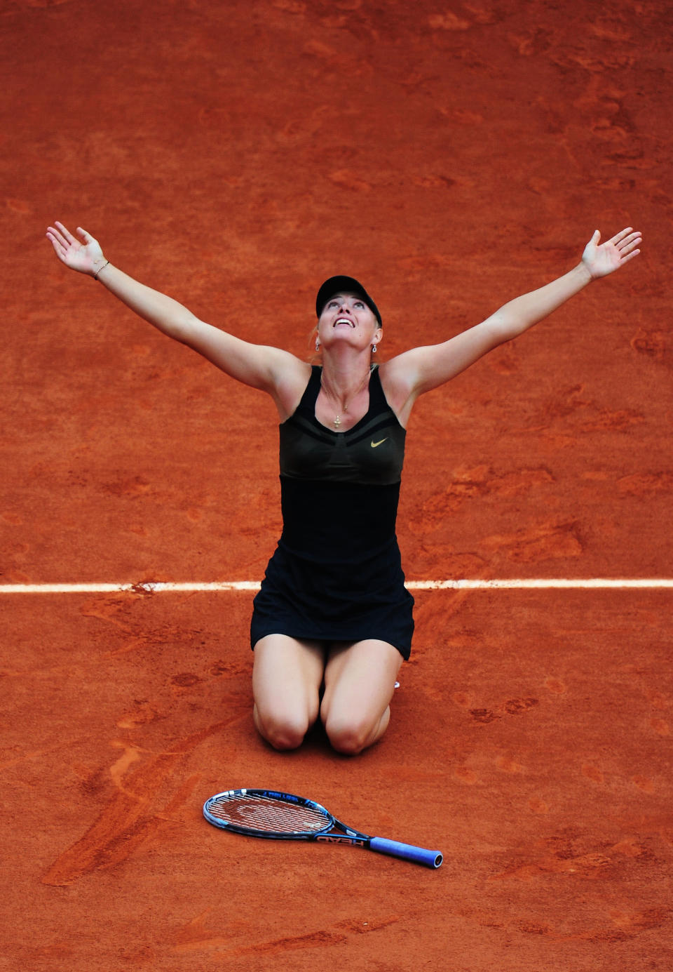 PARIS, FRANCE - JUNE 09: Maria Sharapova of Russia celebrates victory in the women's singles final against Sara Errani of Italy during day 14 of the French Open at Roland Garros on June 9, 2012 in Paris, France. (Photo by Mike Hewitt/Getty Images)