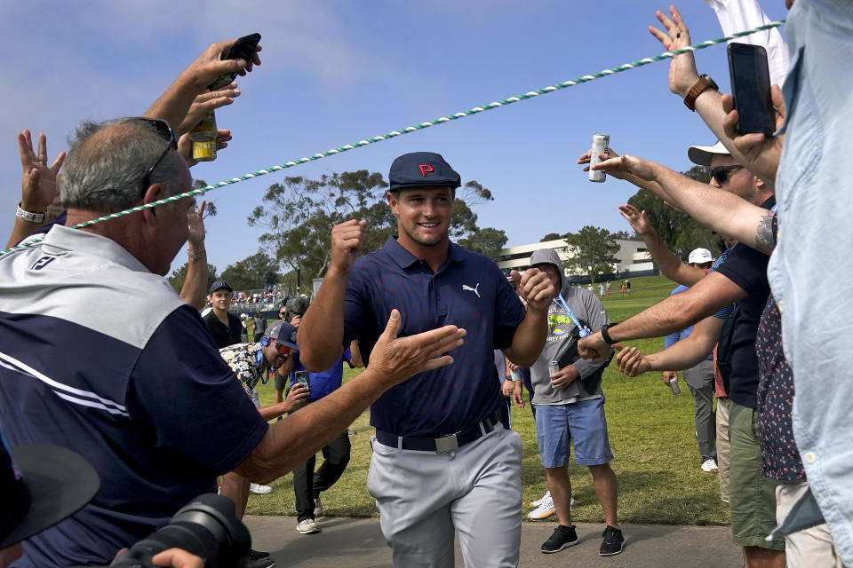 Bryson DeChambeau greets fans as he walks to the 16th tee during the third round of the U.S. Open Golf Championship, Saturday, June 19, 2021, at Torrey Pines Golf Course in San Diego. (AP Photo/Gregory Bull)