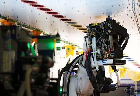 A fixed-bed robot works in a wing assembly station during a media tour of the Boeing 777X at the Boeing production facility in Everett