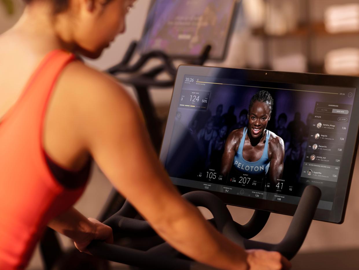 A user watching an instructor on a Peloton bike.