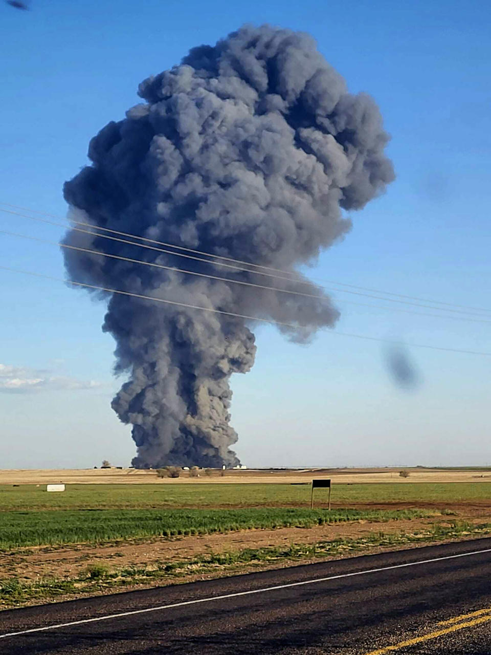 FILE - In this photo provided by Castro County Emergency Management, smoke fills the sky after an explosion and fire at the Southfork Dairy Farms near Dimmitt, Texas, on April 10, 2023. A fire and explosion at the dairy farm in the Texas Panhandle that critically injured one person and killed an estimated 18,000 head of cattle was an accident that started with an engine fire in a manure vacuum truck cleaning part of the massive barn, according to state investigators in a report on April 24. (Castro County Emergency Management via AP, File)