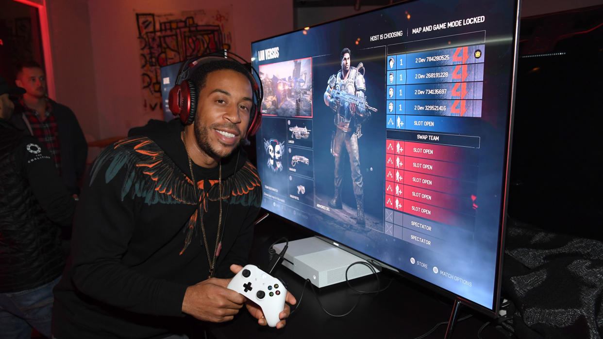 Rapper Ludacris poses next to an Xbox
