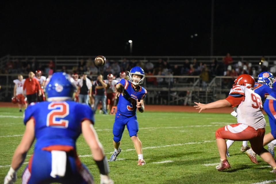 Lenawee Christian's Sam Lutz throws a pass to receiver Jesse Miller during the Division 2 8-Player regional game against Camden Frontier.