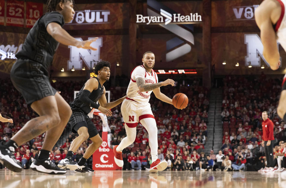 Nebraska's C.J. Wilcher, third from left, dribbles downcourt against Michigan State's Jaden Akins, second from left, during the first half of an NCAA college basketball game Sunday, Dec. 10, 2023, in Lincoln, Neb. (AP Photo/Rebecca S. Gratz)