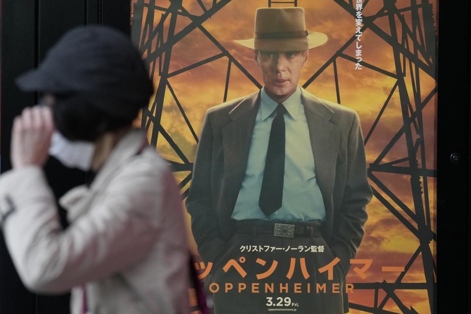 A person walks by a poster to promote the movie "Oppenheimer" Friday, March 29, 2024, in Tokyo. “Oppenheimer” finally premiered Friday in the nation where two cities were obliterated 79 years ago by the nuclear weapons invented by the American scientist who was the subject of the Oscar-winning film. Japanese filmgoers' reactions understandably were mixed and highly emotional. (AP Photo/Eugene Hoshiko)