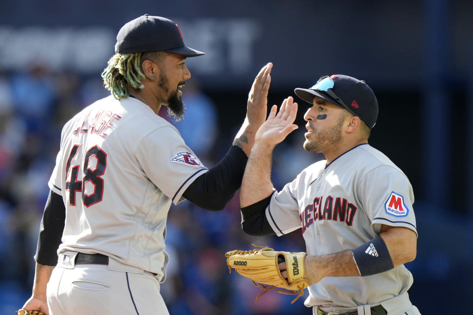 Cleveland Guardians relief pitcher Emmanuel Clase, left, and teammate Ramon Laureano celebrate their team's win against the Toronto Blue Jays after a baseball game in Toronto, Sunday, Aug. 27, 2023. (Frank Gunn/The Canadian Press via AP)