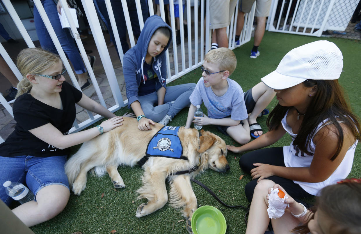 Jacob comforting children in Florida as they attend a prayer vigil for the victims of the shooting at Marjory Stoneman Douglas High School (AP)