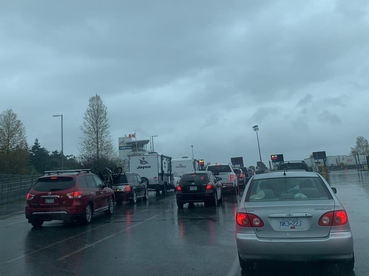 B.C. Ferries passengers are seen lined up outside the Duke Point terminal on Vancouver Island on Monday.  (Mel Hawthorne/Twitter - image credit)