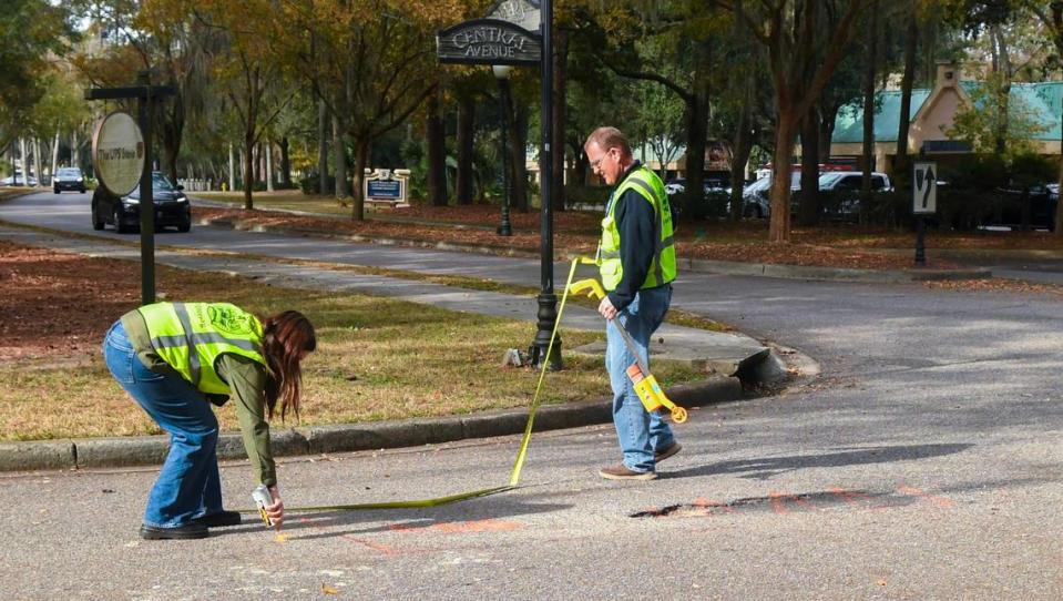 Town of Hilton Head Island transportation department employees Theresa McVey, left, and James Iwanicki finish measuring and highlighting a portion of Central Avenue that needs to be repaired on Hilton Head Island. The town recently accepted ownership of several roads that were once the responsibility of Commercial Property Owners’ Association of Main Street.