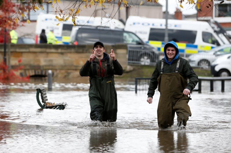 People wade through the floodwater in Bentley, north of Doncaster