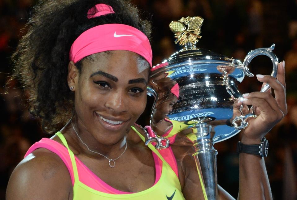 Serena Williams of the US holds the trophy as she celebrates after victory in her women's singles final match against Russia's Maria Sharapova on day thirteen of the 2015 Australian Open tennis tournament in Melbourne on January 31, 2015. (Photo by Mal Fairclough/AFP/Getty Images)