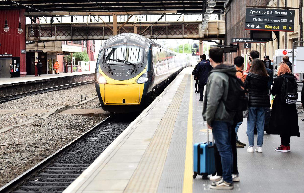 People wait to get on the Avanti West Coast train at Stoke-on-Trent Train Station on May 20, 2021 in Stoke, England.