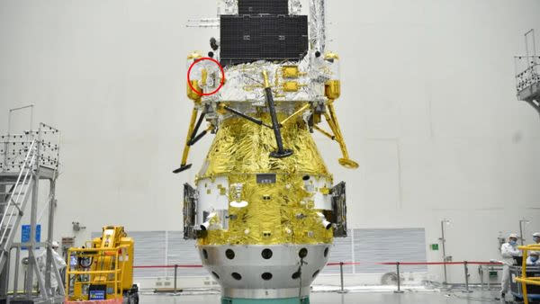     A lunar lander with a small rover strapped to the side. 