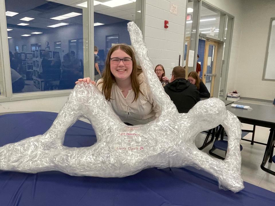 Eighth-grader Lyra Beaudain poses with a striking sculpture done in packing tape. She said she had a great time building it with her friends Claire Davis, Taylor Owens and Carolina Arehart for the annual Fine Arts Night held at Hardin Valley Middle School Tuesday, April 12, 2022.