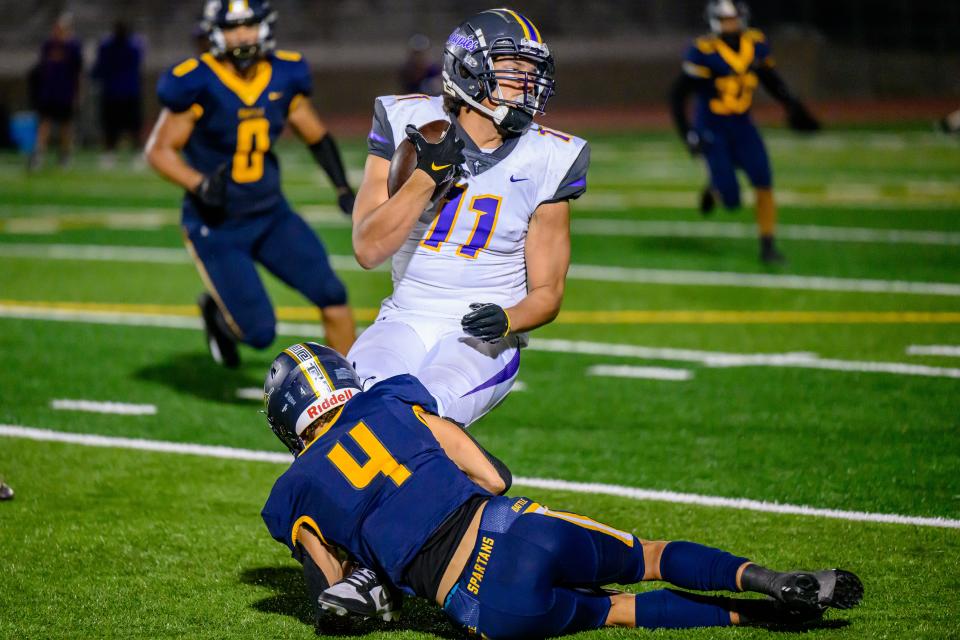 Battle's Jayden Donnelly (4) brings down Hickman's Brock Camp (11) during game against Hickman at Battle High School on Sept. 15, 2023, in Columbia, Mo.