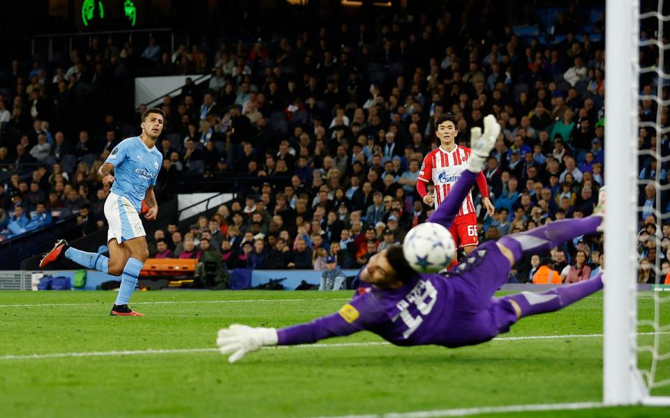 Manchester City's Rodri scores their third goal past