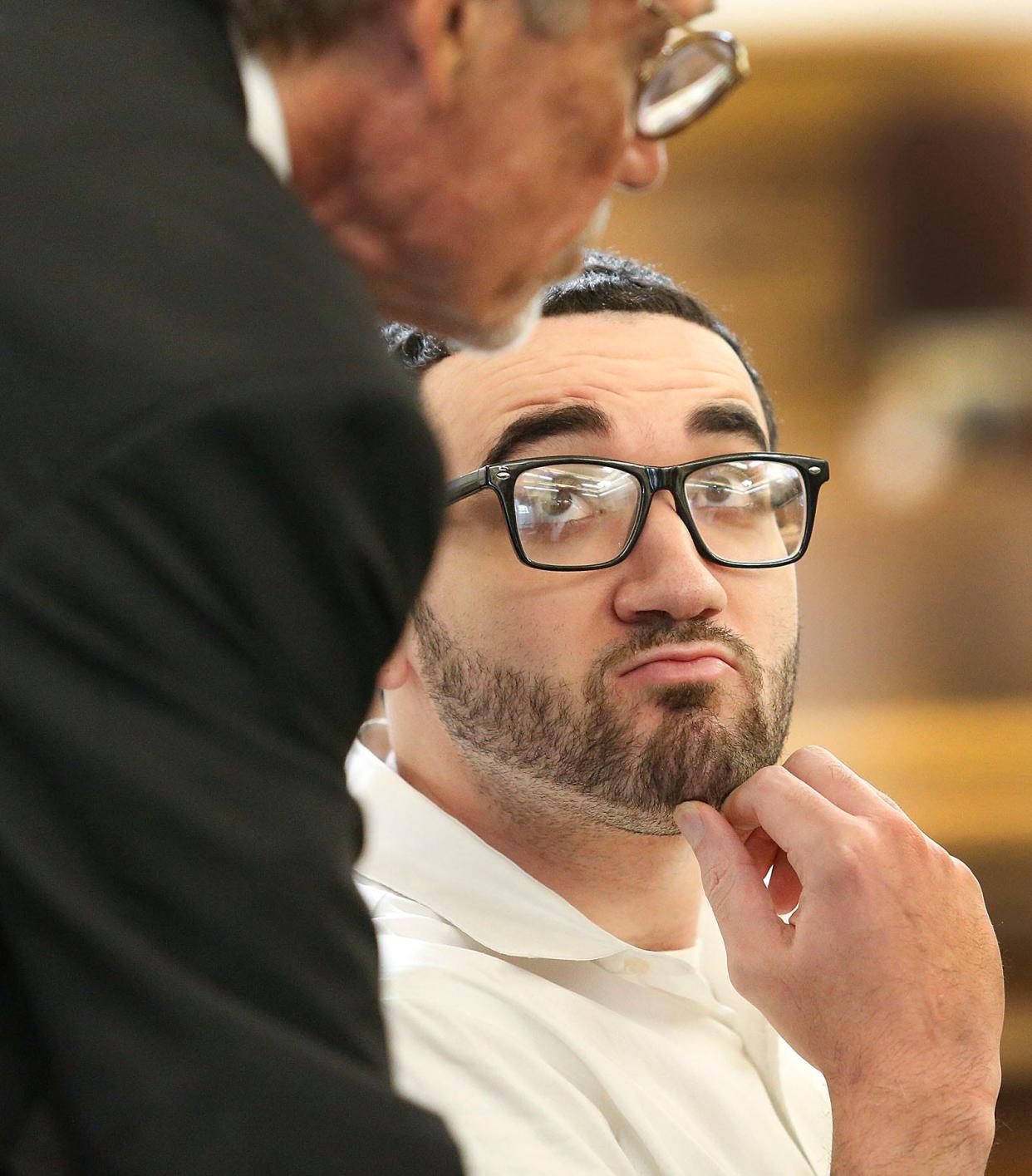 Defendant Emanuel Lopes listens to his lawyer Larry Tipton before a new juror is selected from the alternates Wednesday during his murder trial.