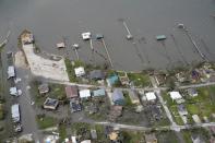 Buildings and homes are damaged in the aftermath of Hurricane Laura Thursday, Aug. 27, 2020, near Lake Charles, La. (AP Photo/David J. Phillip)