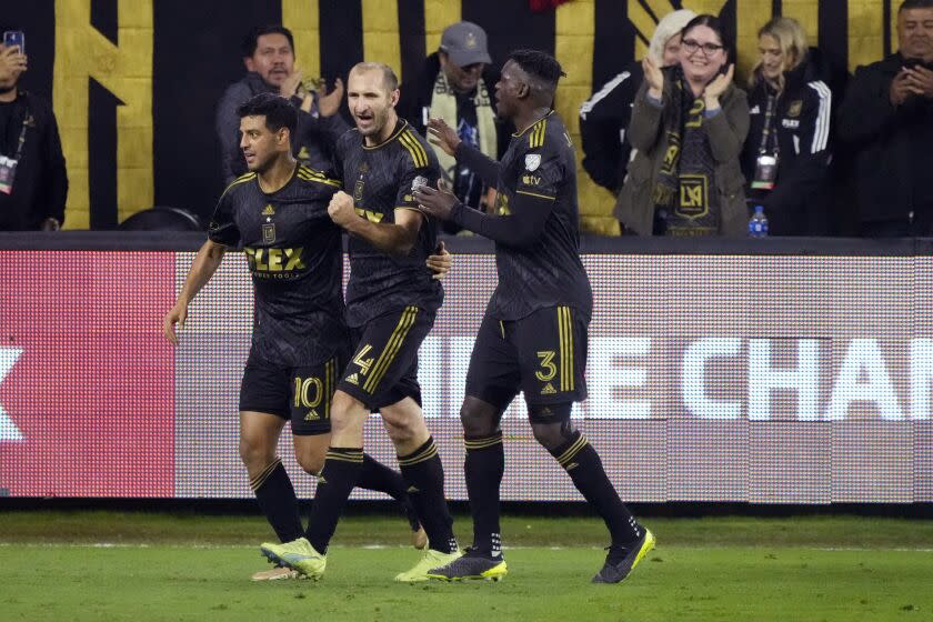 Los Angeles FC's Carlos Vela (10) celebrates his goal against Alajuelense with Giorgio Chiellini (14) and Jesus Murillo (3) during the second half of a CONCACAF Champions League soccer match Wednesday, March 15, 2023 , in Los Angeles.  (AP Photo/Marcio Jose Sanchez)