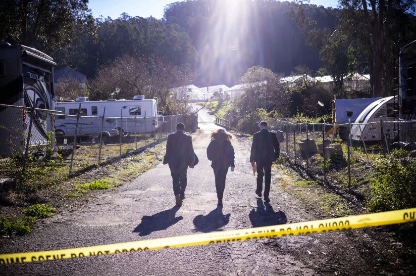 FBI officials walk towards from the crime scene at Mountain Mushroom Farm, Tuesday, Jan. 24, 2023, after a gunman killed several people at two agricultural businesses in Half Moon Bay, Calif. Officers arrested a suspect in Monday's shootings, 67-year-old Chunli Zhao, after they found him in his car in the parking lot of a sheriff's substation, San Mateo County Sheriff Christina Corpus said. (AP Photo/Aaron Kehoe)