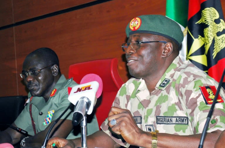 New head of the five-nation Multi-National Joint Task Force Major-General Iliya Abbah (R) speaks, flanked by his predecessor Nigerian army chief Major General Tukur Buratai, during a handover ceremony in Abuja on July 31, 2015