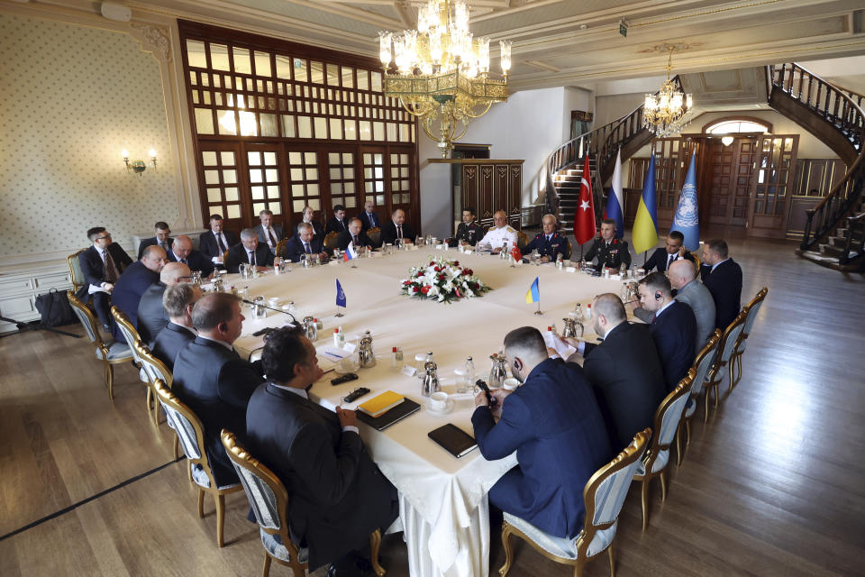 In this handout photo provided by the Turkish Defence Ministry, Russian, top left, and Ukranian, right, delegations meet along with United Nation observers, left, and Turkish Defence Ministry members in Istanbul, Turkey, Wednesday, July 13, 2022. Military delegations from Russia and Ukraine held their governments' first face-to-face talks in months Wednesday as they tried to reach an agreement on a United Nations plan to export blocked Ukrainian grain to world markets through the Black Sea. (Turkish Defence Ministry via AP)