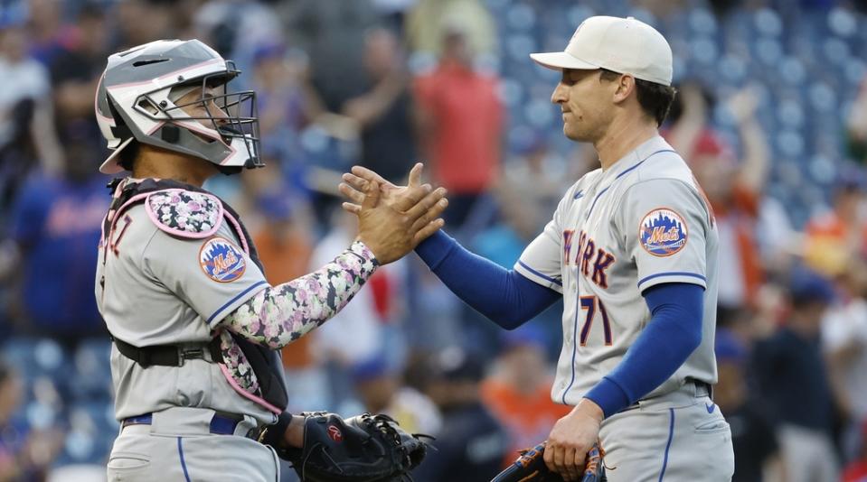 New York Mets relief pitcher Zach Muckenhirn (71) celebrates with Mets catcher Francisco Alvarez (4) after their game against the Washington Nationals at Nationals Park.