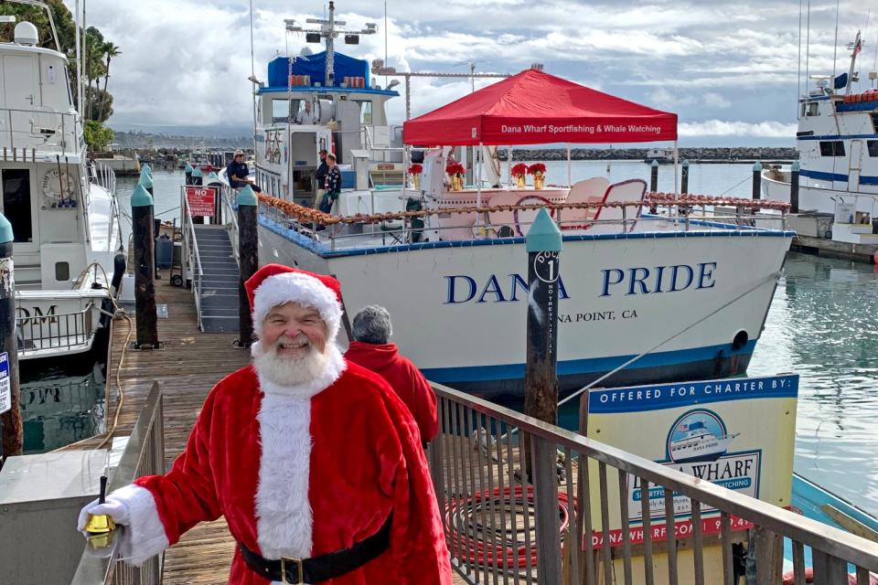 Santa Claus standing on a dock in Dana Point harbor.