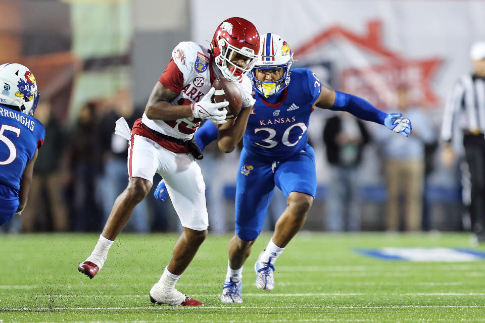 Dec 28, 2022; Memphis, TN, USA; Arkansas Razorbacks wide receiver Jaedon Wilson (13) catches a pass against Kansas Jayhawks linebacker Rich Miller (30) in the first quarter in the 2022 Liberty Bowl at Liberty Bowl Memorial Stadium. Mandatory Credit: Nelson Chenault-USA TODAY Sports