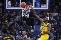Indiana Pacers' Isaiah Jackson (22) dunks against Atlanta Hawks' John Collins during the first half of an NBA basketball game Friday, Jan. 13, 2023, in Indianapolis. (AP Photo/Darron Cummings)