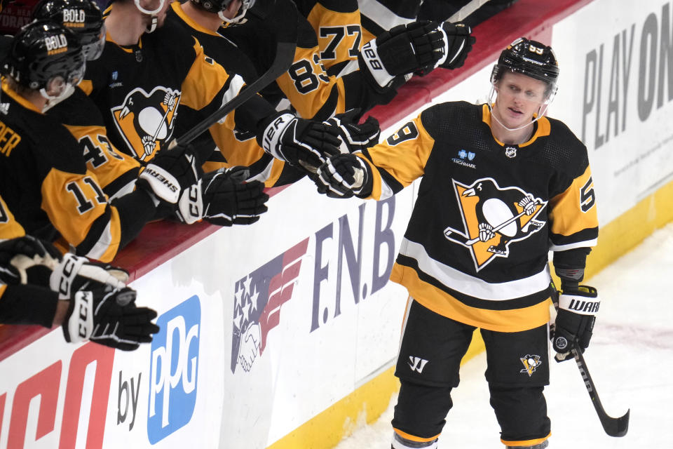 Pittsburgh Penguins' Jake Guentzel (59) returns to the bench after scoring during an NHL hockey game against the Toronto Maple Leafs in Pittsburgh, Saturday, Nov. 25, 2023. (AP Photo/Gene J. Puskar)