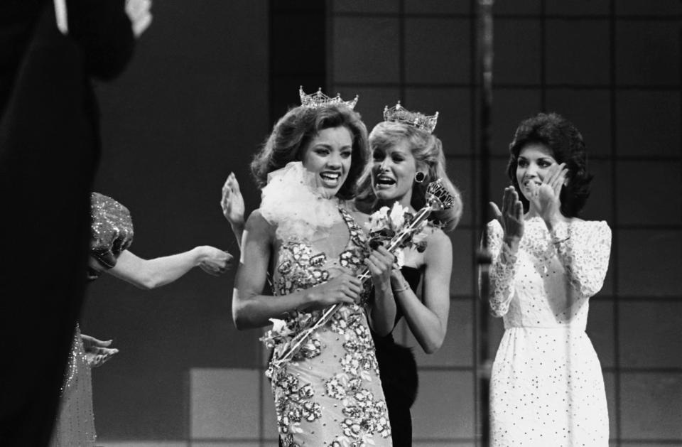 Vanessa Williams, the new Miss America, left, is crowned, Sept. 17, 1983 in Atlantic City, N.J., by the outgoing Miss America, Debra Maffett. (AP Photo)