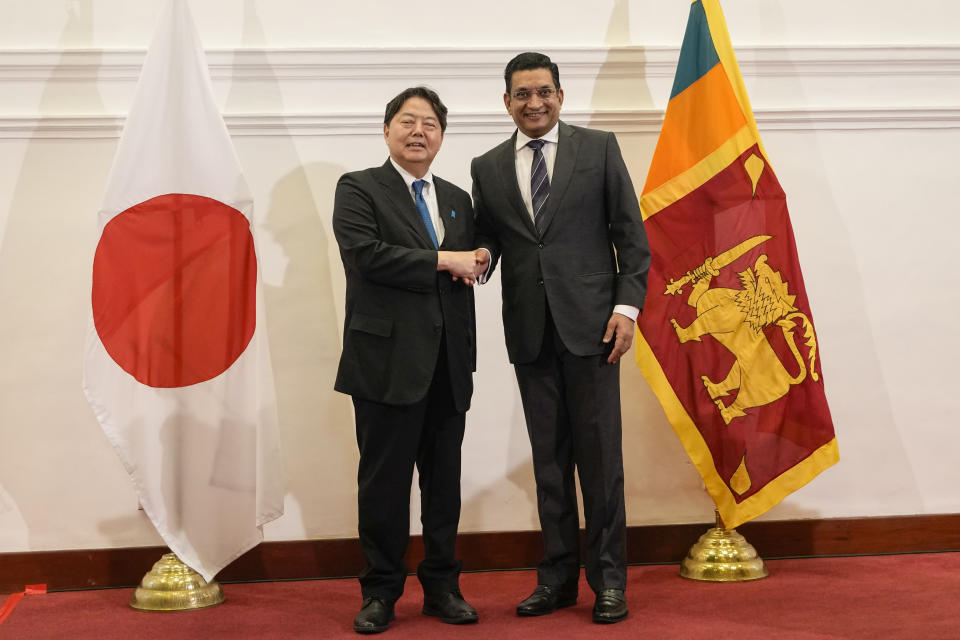 Japanese foreign minister Yoshimasa Hayashi, left, shakes hands with his Sri Lankan counterpart Ali Sabry after their meeting in Colombo, Sri Lanka on Saturday, July 29, 2023. (AP Photo/Eranga Jayawardena)